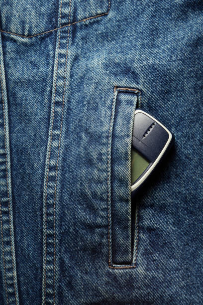 istock Old-fashioned push-button phone inside of denim jcket's pocket 2181463023