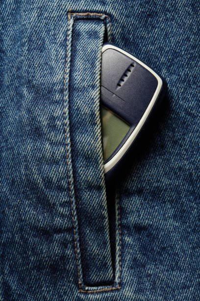 istock Old-fashioned push-button phone inside of denim jcket's pocket 2181463039