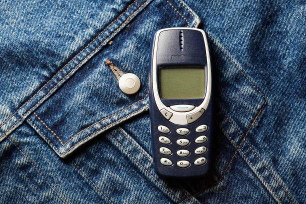 istock Old-fashioned push-button phone on denim jcket's pocket 2181463182