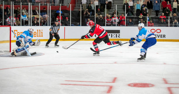 istock Ice Hockey Goalie Blocks Opponent's Shot 2181463768