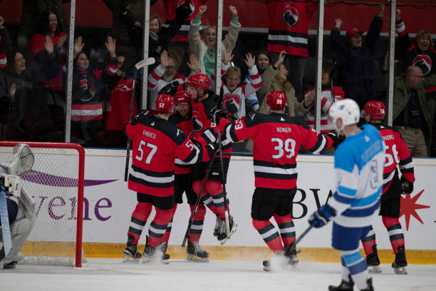 istock Intense Celebration by Red Team Players after Scoring in Hockey Match 2181463965
