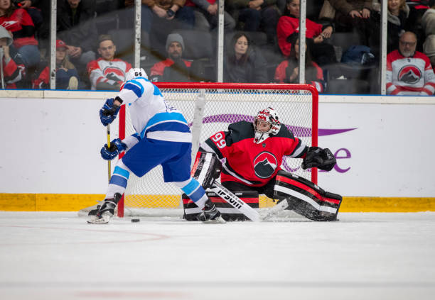 istock Hockey Goalie Defends Against Opponent's Attack 2181464240