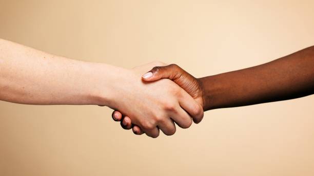istock Handshake of diverse two people of different ethnicities. 2181464509