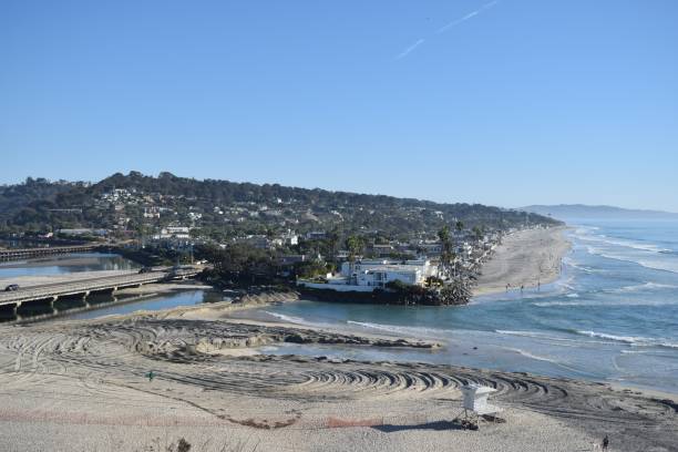 istock Coastal town with sandy beach and blue sky. 2181464670