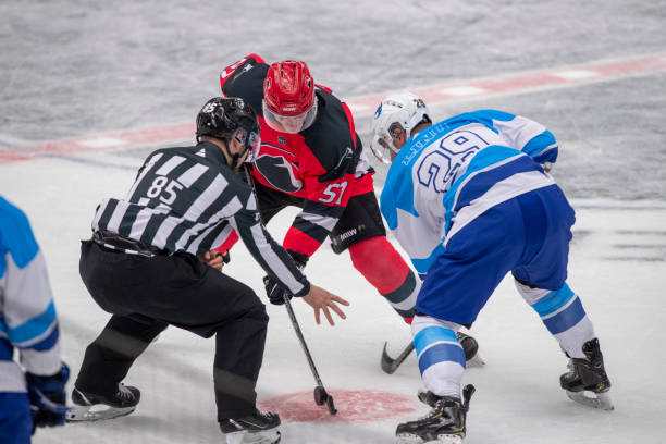 istock Intense Face-Off Between Opposing Hockey Players 2181464706