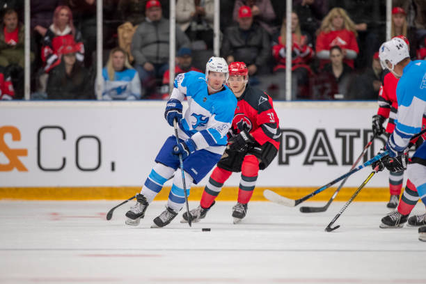 istock Intense Ice Hockey Play with Player dribbling the puck 2181464759