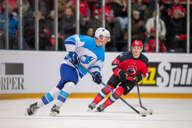 istock The player skillfully dribbles the puck, evading defenders with quick movements and precise passes. 2181464907