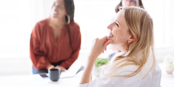 istock A diverse group of four women collaborate brainstorm around a table, sharing ideas and brainstorm with a tablet, showcasing teamwork and creativity. 2181469359