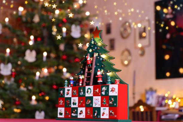 istock Three-dimensional Advent Calendar in Front of Christmas Tree in Christmassy illuminated Room 2181470857