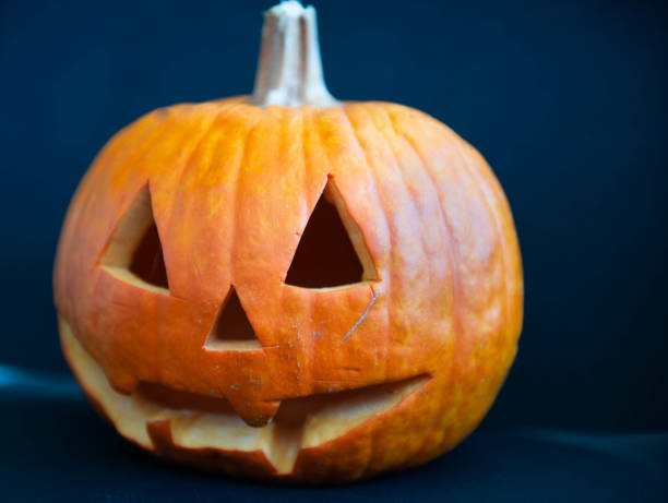 istock Halloween - ready pumpkin with triangle - shaped eye and nose openings and a toothless mouth opening 2181471126