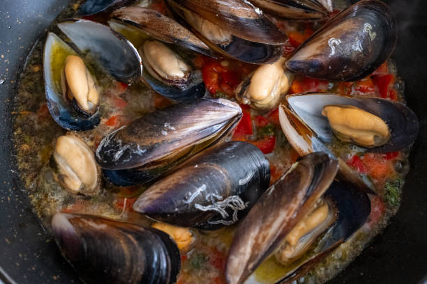 istock Cooking mussels in a black pan 2181471693