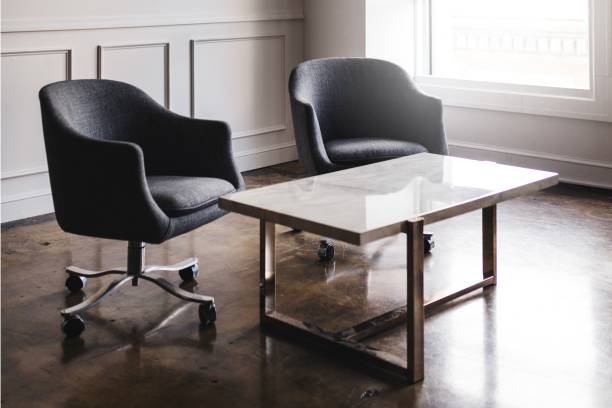istock Modern office chairs and a sleek marble table in a minimalist office. 2181472357