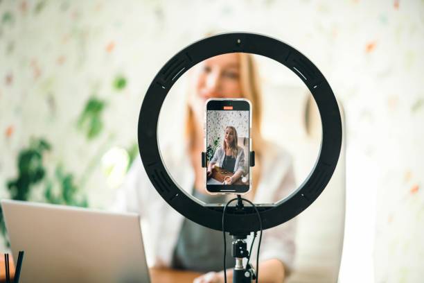 istock coach or influencer recording content with professional light and phone, creating a personal connection with viewers on blog 2181472935