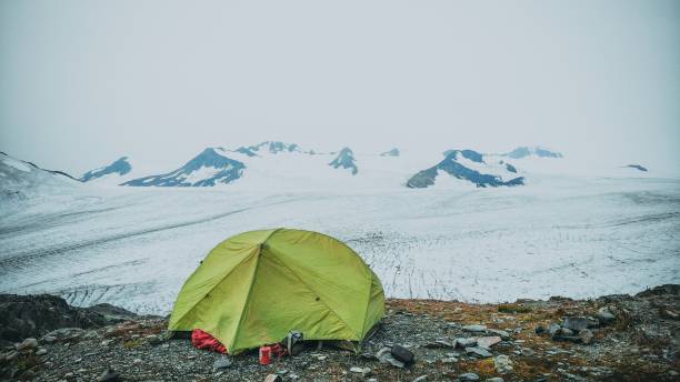 istock Green tent in snowy mountain landscape 2181473563