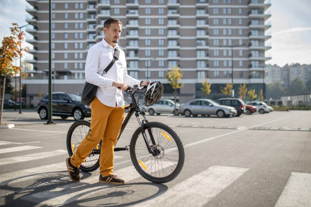 istock Young handsome man, in business casual clothes, going to work by bicycle. 2181473607