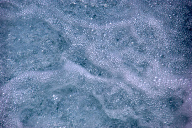 Turquoise ocean sea water white wave pattern splashing deep blue sea. Seascape dark ocean background wave splash on rock. Tropical sea beach in summer seaside outdoor. Water Surface blue wave pattern