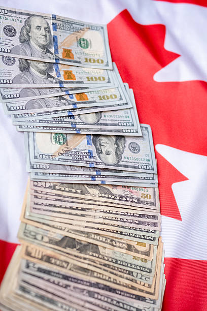 istock Counting US dollars on the canada flag 2181475287