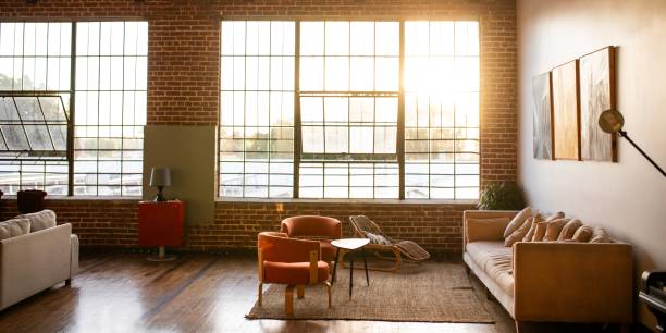 istock Spacious loft with large windows, brick walls, and wooden ceiling. 2181475382