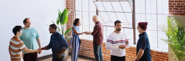 istock Diverse group in casual attire socializing in a modern loft for new community and connection. 2181475574