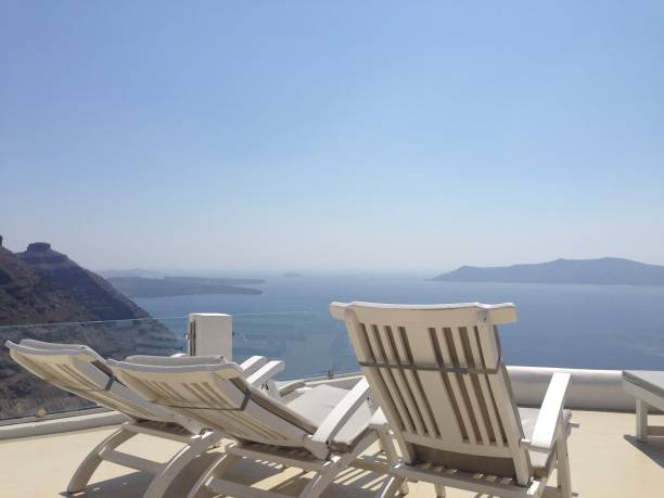 istock Reclining Chairs Overlooking Santorini Waters 2181475743