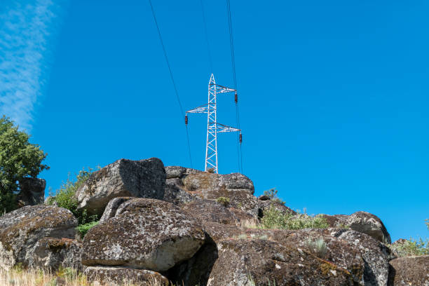 istock High voltage electric pole on top of the rocks 2181476523