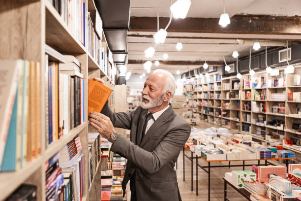 istock Elderly Book Lover Immersed in His Favorite Bookstore 2181476528