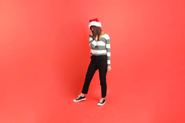 istock Woman wearing Santa hat 2181478021