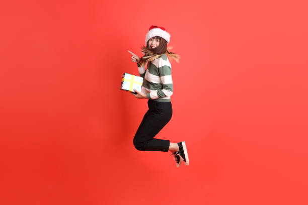 istock Woman wearing Santa hat 2181478823