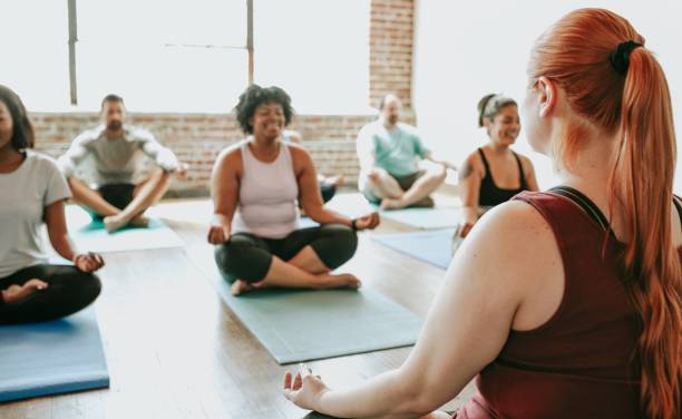 istock Diverse group of men and women practicing yoga. 2181479652
