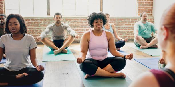Diverse group of men and women practicing yoga.