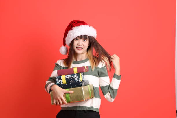 istock Woman wearing Santa hat 2181480073