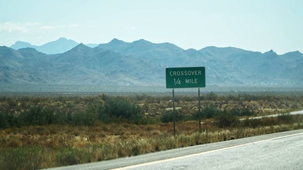 istock Road sign CROSSOVER 1/4 MILE mountain view background 2181480833