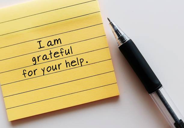 istock Paper yellow note with text written - I am grateful for your help - message to thank anyone for their support - write a card of appreciation 2181484957