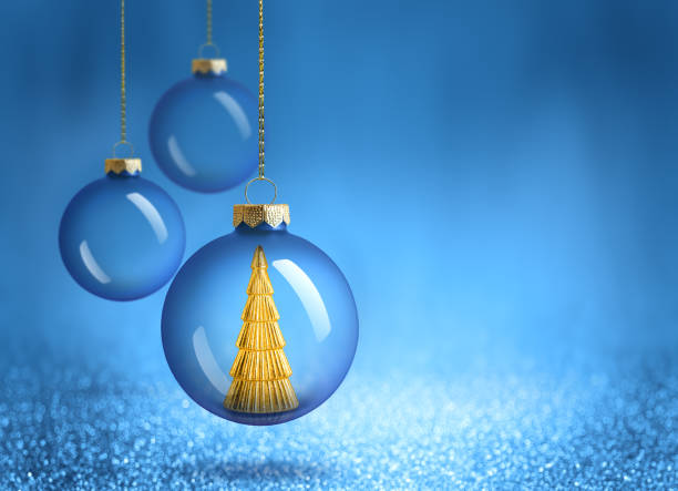 istock Christmas bauble with gold tree decoration inside. New Year ornaments on blue sparkling background. 2181486686