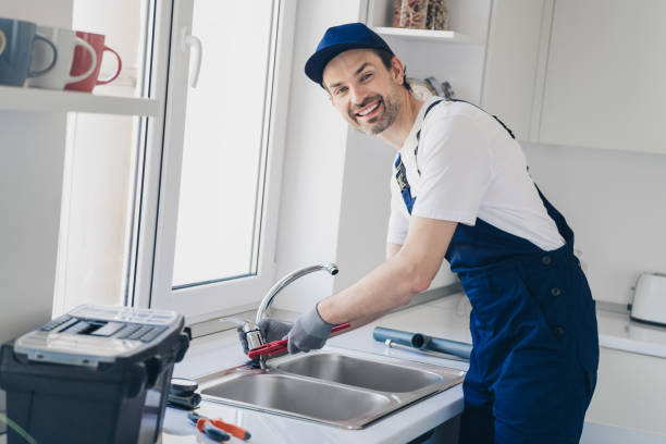 istock Professional handyman repairing kitchen sink with tools, smiling technician home plumbing perfection in modern apartment setting. 2181487877