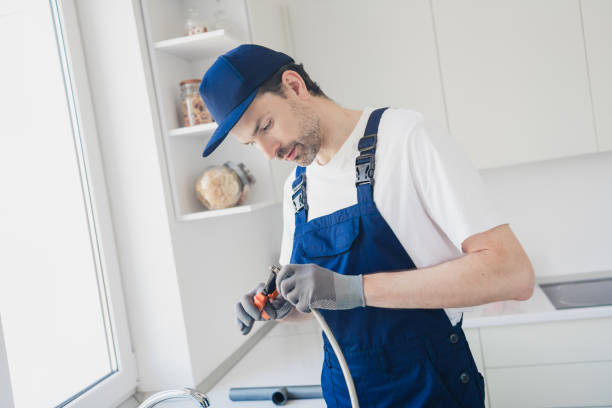 istock Dedicated young handyman skillfully performing plumbing tasks during a home renovation in a bright kitchen setting 2181487896
