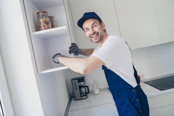 istock Cheerful handyman fixing kitchen cabinets, showcasing professionalism and skill in home renovation 2181487938