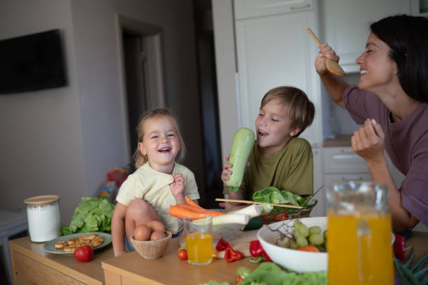 istock Children have fun making dinner with their mother 2181489280