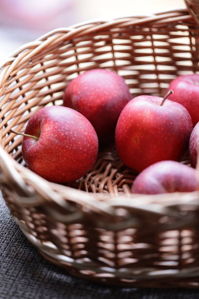 istock Fresh red apples stored in a woven wicker basket 2181490173