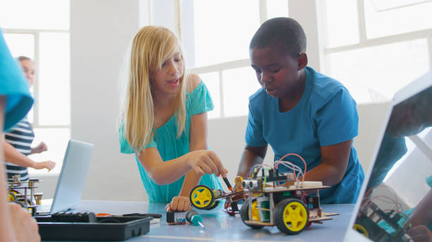 istock Students With Female Teacher In School Computer Class Building And Programming Robot Vehicle 2181490248