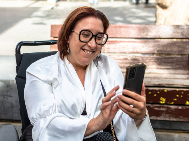 istock Female Wheelchair User Engaging with Technology Outdoors 2181490593