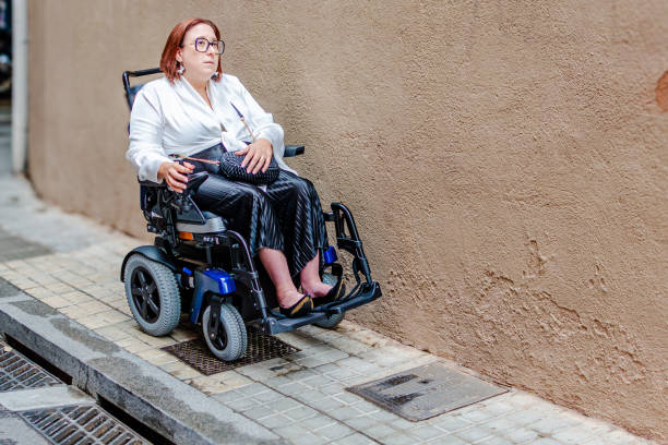 istock Wheelchair User Navigates Narrow Urban Sidewalk Path 2181490971