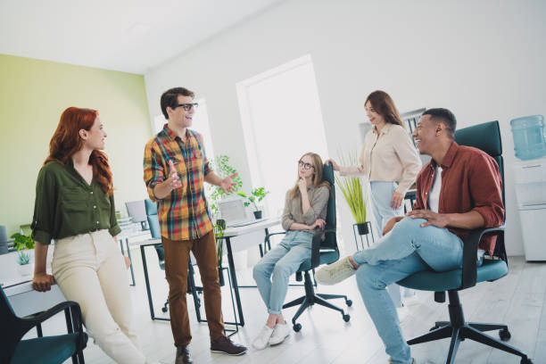 istock Photo of group young corporate workers communicate chatting workstation office business center indoors 2181491074