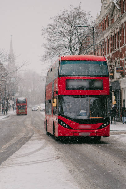 istock Iconic red London bus under the snow 2181495050