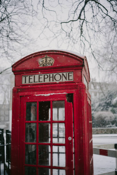 Red English telephone box  covered in snow in North Yorkshire village of Cowling