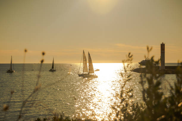 Seascape view with sailing boats in the morning at Antibes, France