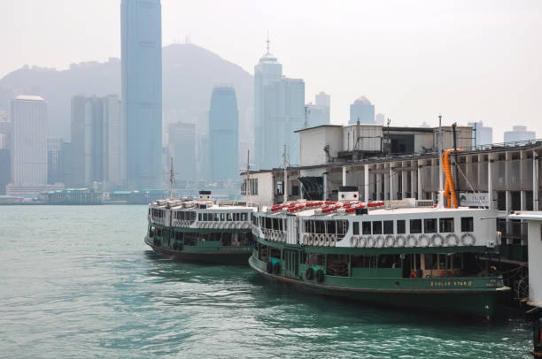 Hong Kong - October 26, 2021 : A Star Ferry carries passengers across Victoria Harbour in Hong Kong. The Star Ferry plies its way between Hong Kong Island and Kowloon.