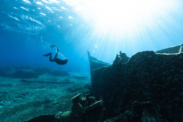 istock Freediver Swimming in Deep Sea With Sunrays. 2181497805