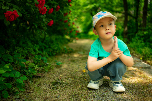 A young boy smiles, and his innocent expression and bright eyes reflect the carefree joy of childhood