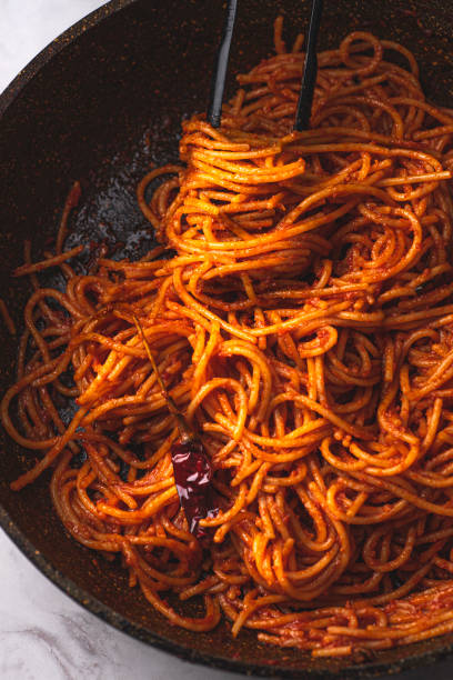istock Spaghetti all'assassina is a typical Apulian recipe, Bari. Trendy first course, pasta cooked directly in a pan with tomato sauce, for a charred, crunchy and spicy flavor, close up, new Italian pasta 2181500356